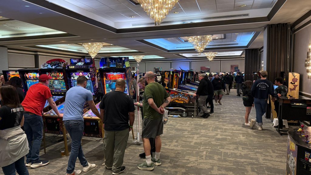Pinball players on the main convention floor at Pintastic New England 2026 in Marlborough, Massachusetts